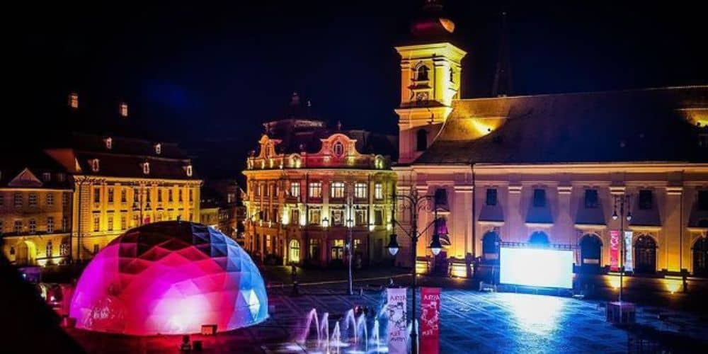 an image of dounwtown Sibiu Romania at night during the astra film festival