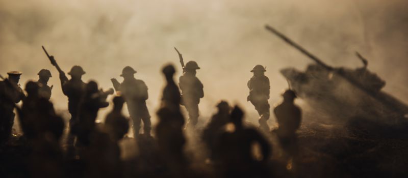 military silhouettes fighting war against foggy sky