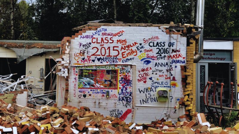 a dilapidated shack with graffiti in middle america