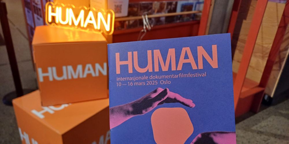 a stack of booklets at HUMAN IDFF Oslo 2025